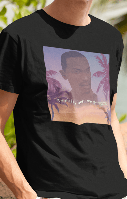 A man wearing a black T-shirt with an aesthetic miami imagery and cj from GTA San Andreas in the background written &quot;Ah shit, here we go again.&quot;