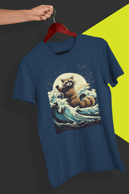 A navy blue T-shirt with an aesthetic racoon in the waves, is hung on a red hanger, held by a hand against a split black and yellow background.