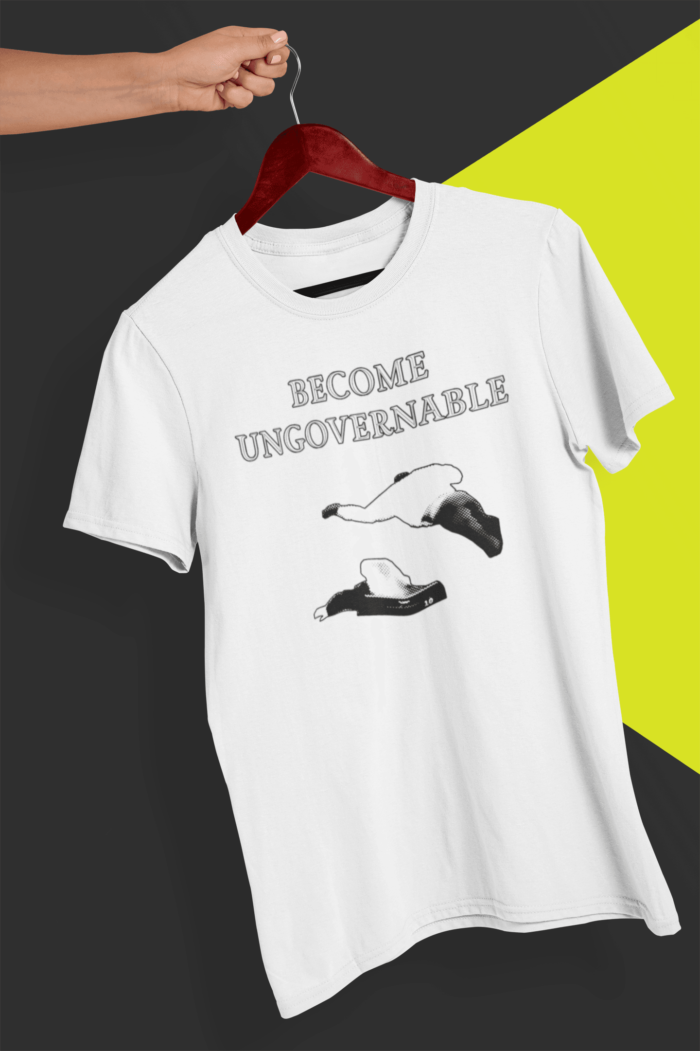 A white T-shirt with &quot;BECOME UNGOVERNABLE&quot; in black text and a black graphic of a leaping man onto a judge, held on a red hanger against a split black and yellow background.