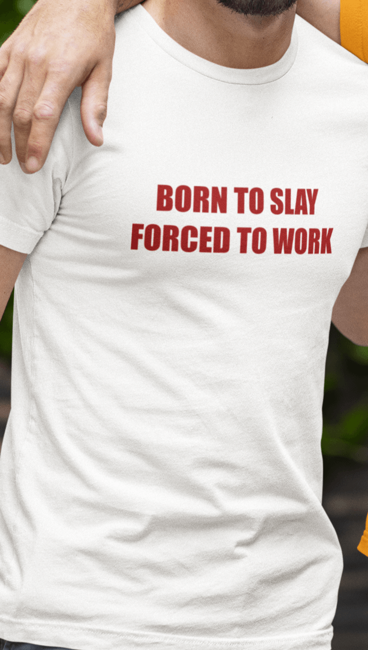 A man wears a white T-shirt that says &quot;Born to slay, forced to work&quot;.