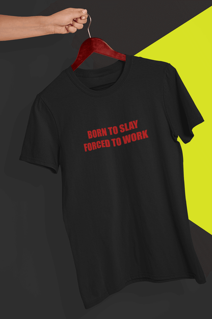 A black T-shirt that says &quot;Born to slay, forced to work&quot;, held by a hand against a split black and yellow background.