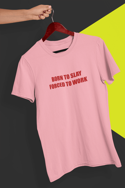 A pink T-shirt that says &quot;Born to slay, forced to work&quot;, held by a hand against a split black and yellow background.