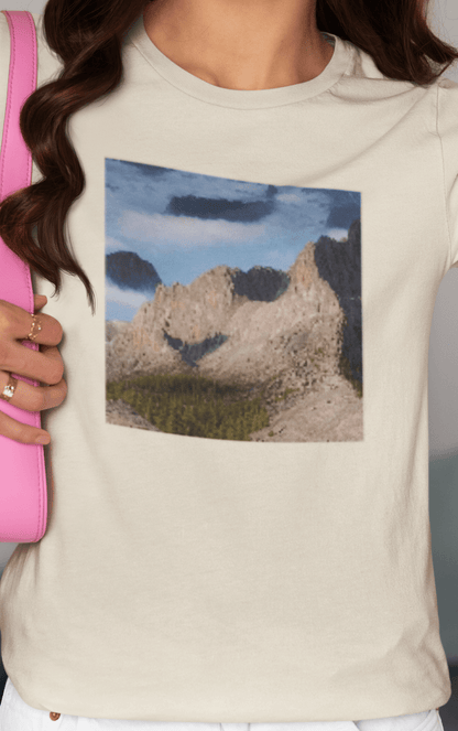 A woman wears an off-white T-shirt featuring an AI generated landscape that looks like a cat taking a selfie staring at the camera