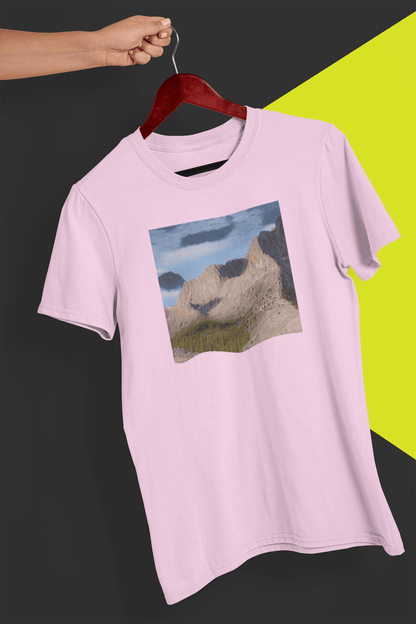 A pink T-shirt featuring an AI generated landscape that looks like a cat taking a selfie staring at the camera, held by a hand against a split black and yellow background.