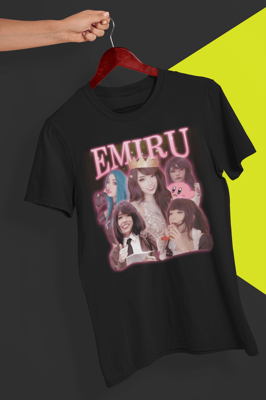 A black T-shirt with a bootleg design of twitch streamer Emiru written &quot;Emiru&quot; on top, is hung on a red hanger, held by a hand against a split black and yellow background.