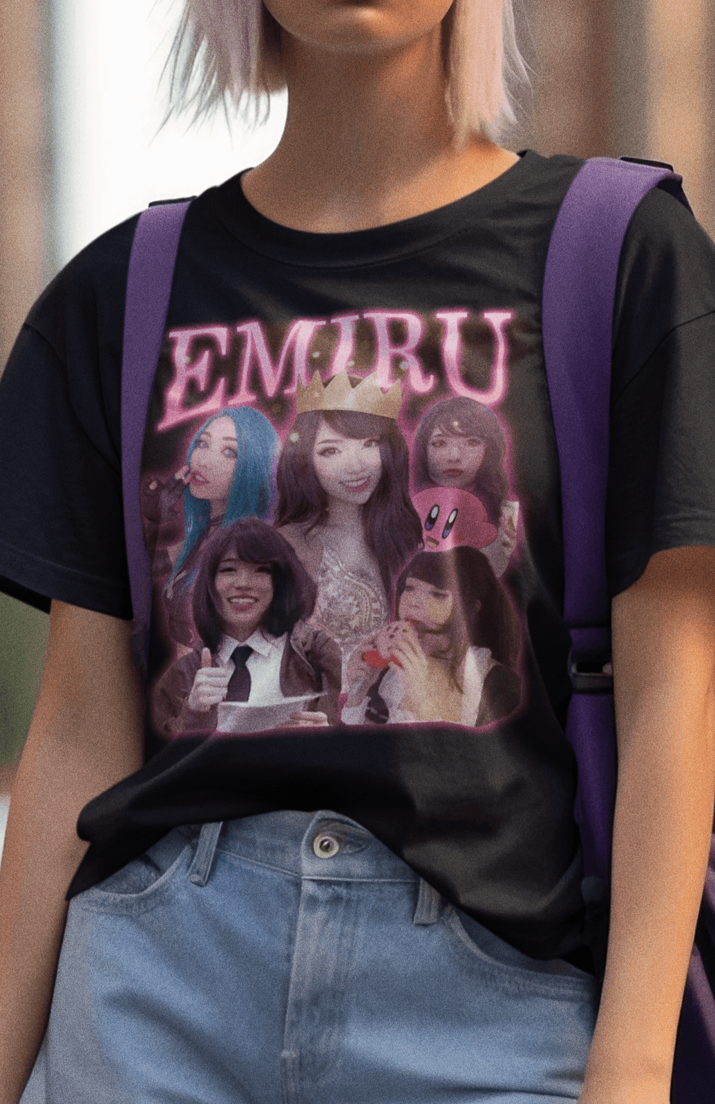 A woman wears a black T-shirt featuring a bootleg design of twitch streamer Emiru written &quot;Emiru&quot; on top.