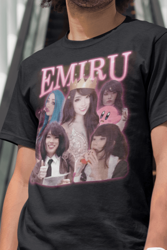 A man wears a black T-shirt featuring a bootleg design of twitch streamer Emiru written &quot;Emiru&quot; on top.