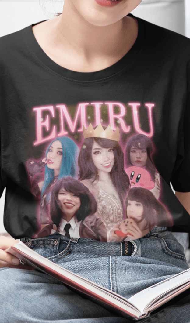 A woman wears a black T-shirt featuring a bootleg design of twitch streamer Emiru written &quot;Emiru&quot; on top.