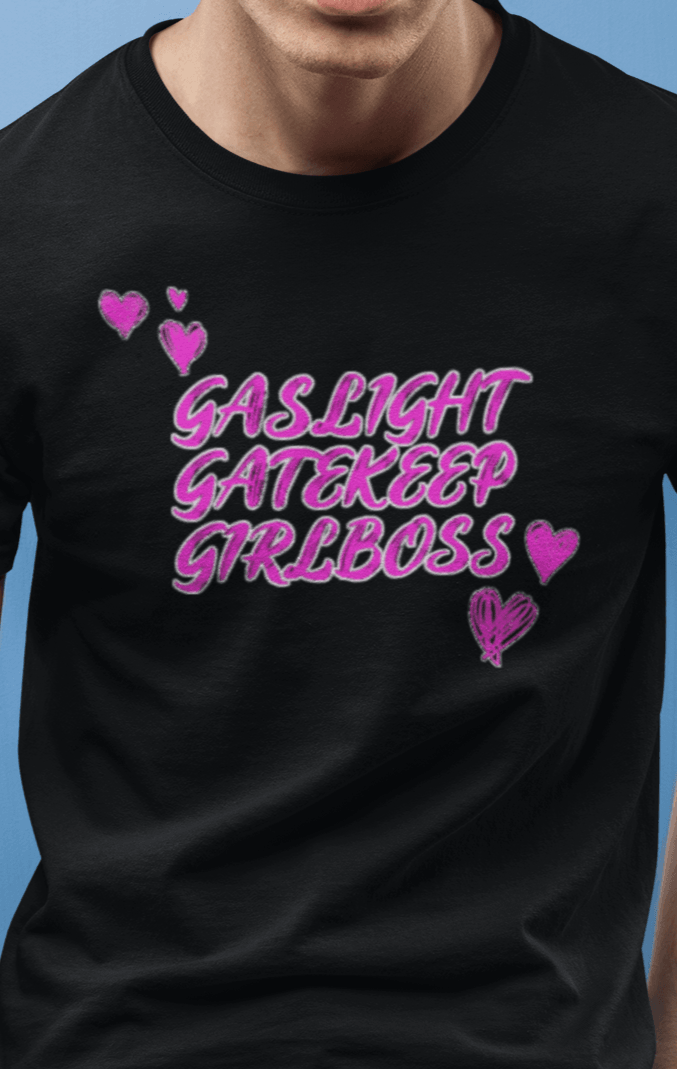 A man wears a black T-shirt that says &quot;Gaslight, Gatekeep, Girlboss&quot;.