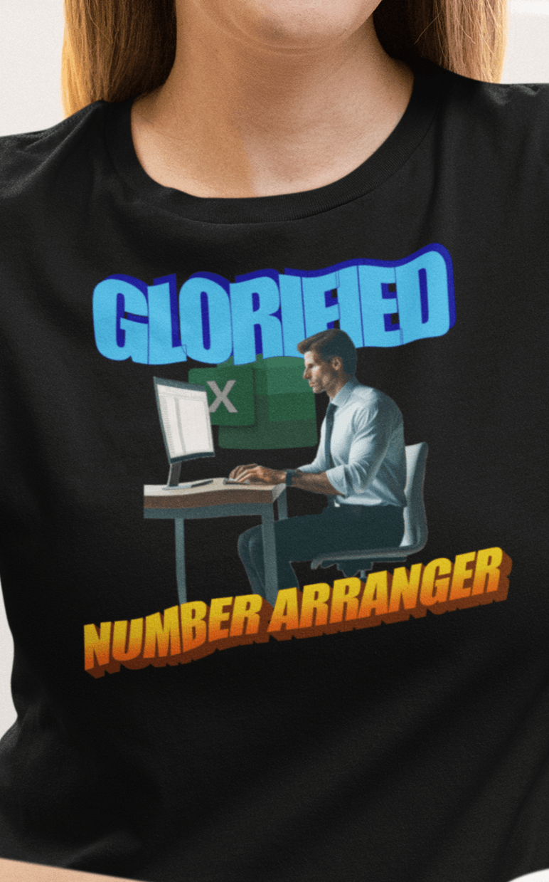 A woman wears a black T-shirt featuring a man sitting on a desk, saying &quot;Glorified Number Arranger&quot;.