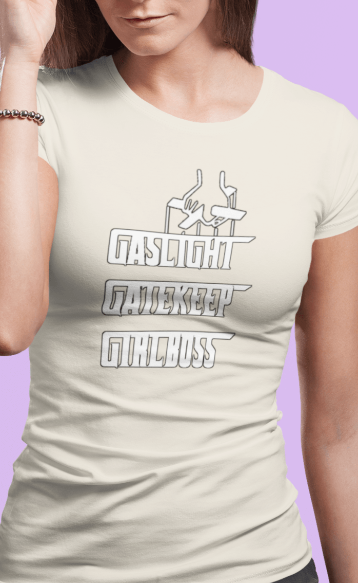 A woman wears an off-white T-shirt that says &quot;Gaslight, Gatekeep, Girlboss&quot;.