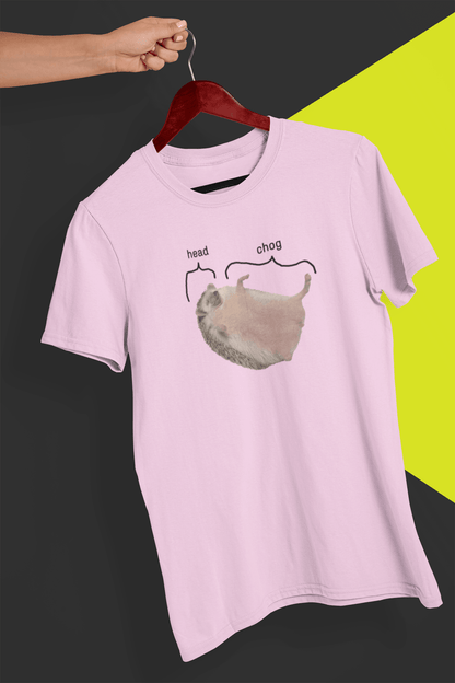 A pink T-shirt featuring a cute hedgehog, which says &quot;head&quot; pointing at his head, and &quot;chog&quot; pointing at the rest of his body, is hung on a red hanger, held by a hand against a split black and yellow background.