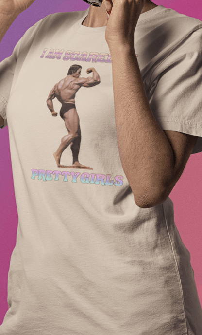 A woman wears an off-white T-shirt featuring the bodybuilder Arnold Schwarzenegger flexing, saying &quot;I am scared of pretty girls&quot;