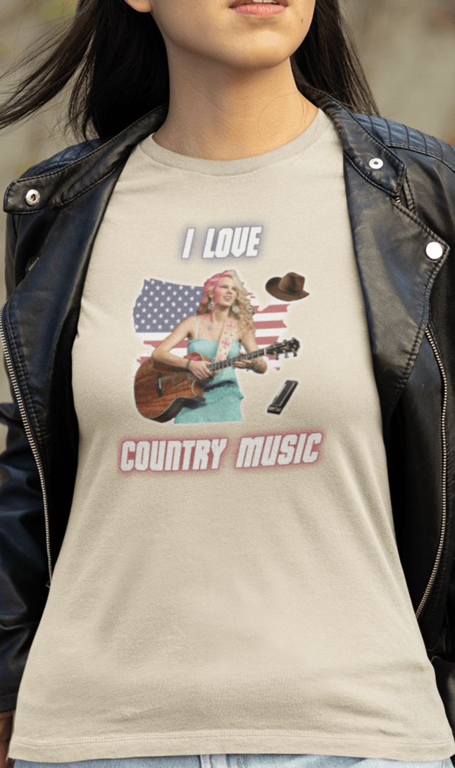 A woman wears an off-white T-shirt featuring Taylor Swift that says &quot;I Love Country Music&quot;.