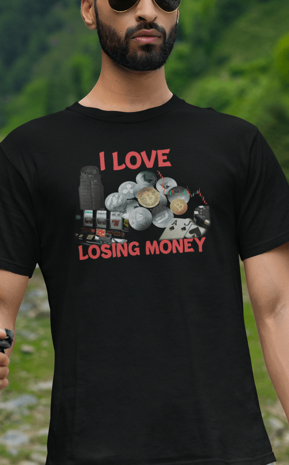 A man wears a black T-shirt with graphs and cryptos written &quot;I Live Losing Money&quot;.