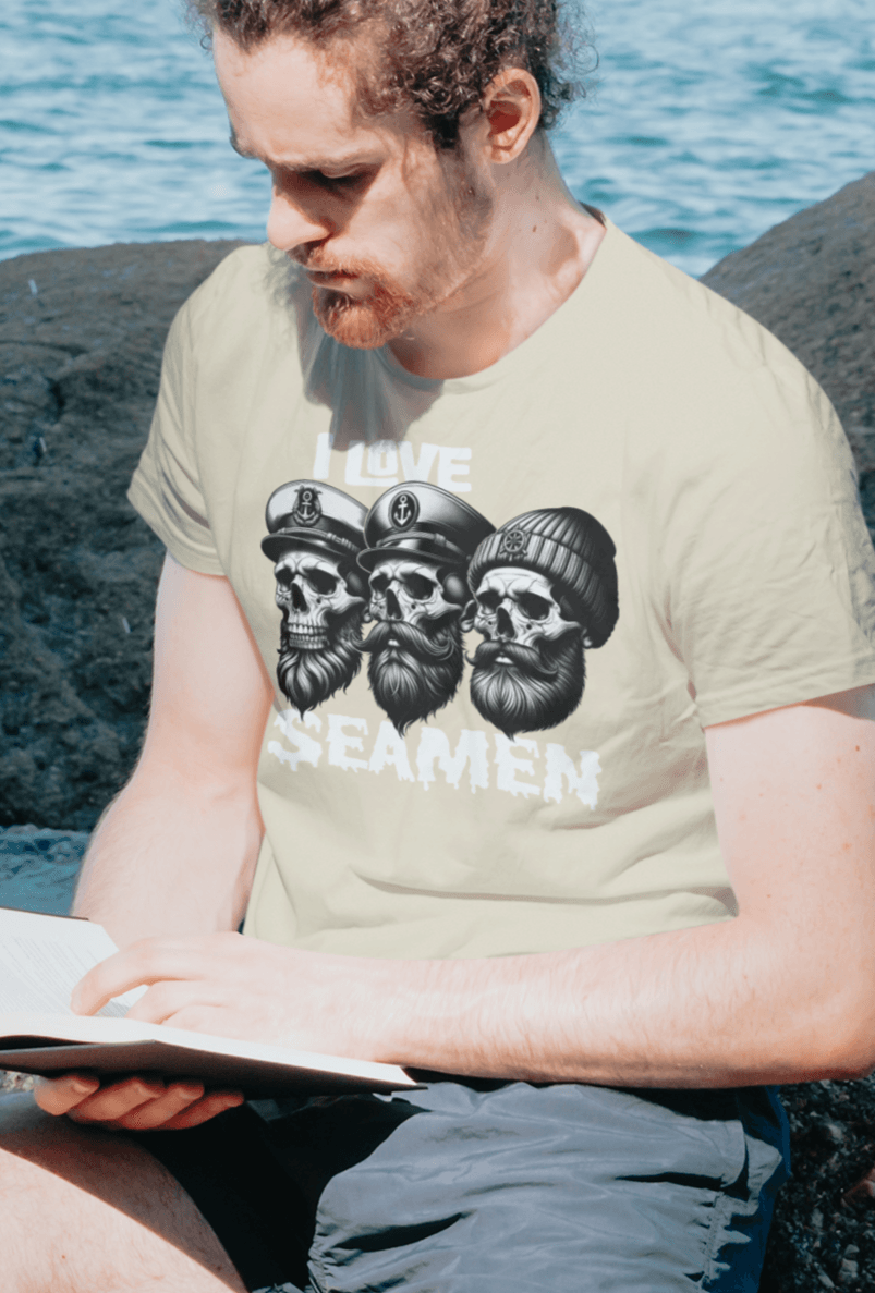 A man sitting reading a book wears an off-white T-shirt three men of the sea written &quot;I Love Seamen&quot;.