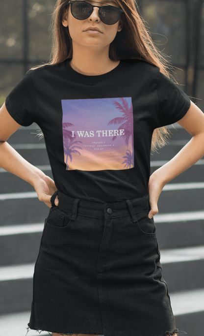 A woman wearing a black T-shirt with an aesthetic miami imagery written &quot;I WAS THERE, Trailer 1, Tuesday, December 5, 9AM ET&quot;