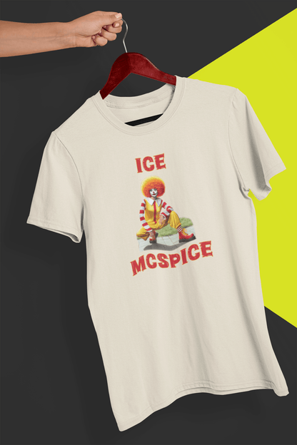 An off-white T-shirt featuring a woman who looks like the rapper Ice Spice dressed as Ronald McDonald, saying &quot;Ice McSpice&quot;, held by a hand against a split black and yellow background.