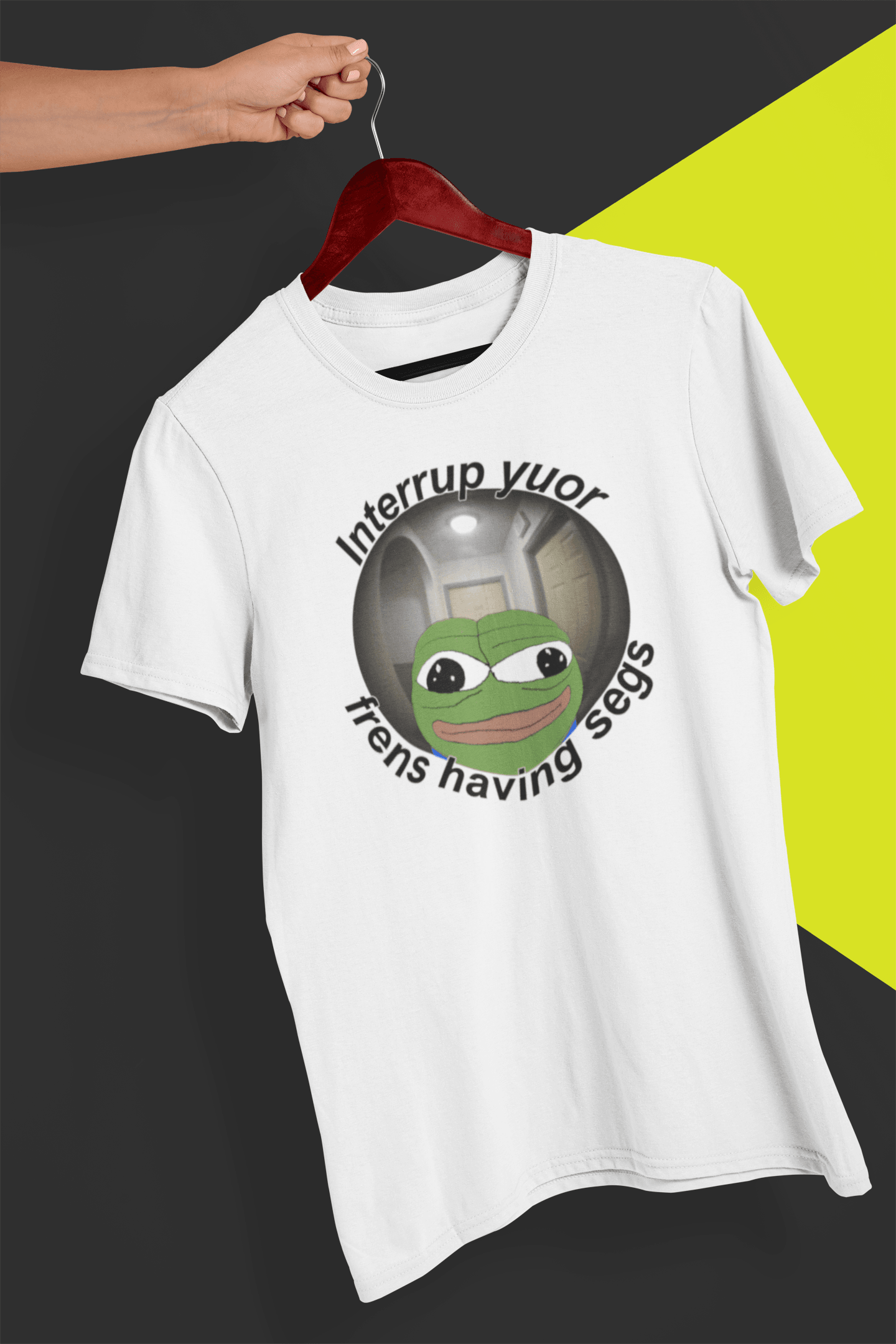 A white T-shirt featuring a peepo frog on the other side of a door peephole, saying &quot;Interrupt your friends having sex&quot; full of typos, held by a hand against a split black and yellow background.