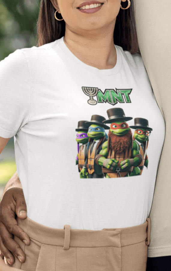 A woman wears a white T-shirt featuring Teenage Mutant Ninja Turtles wearing hasidic attire, and text that says &quot;TMNT&quot; with the &quot;T&quot; stylized as a menorah