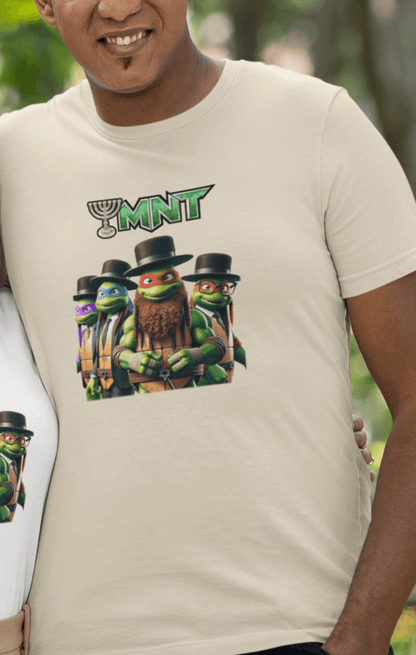 A man wears an off-white T-shirt featuring Teenage Mutant Ninja Turtles wearing hasidic attire, and text that says &quot;TMNT&quot; with the &quot;T&quot; stylized as a menorah