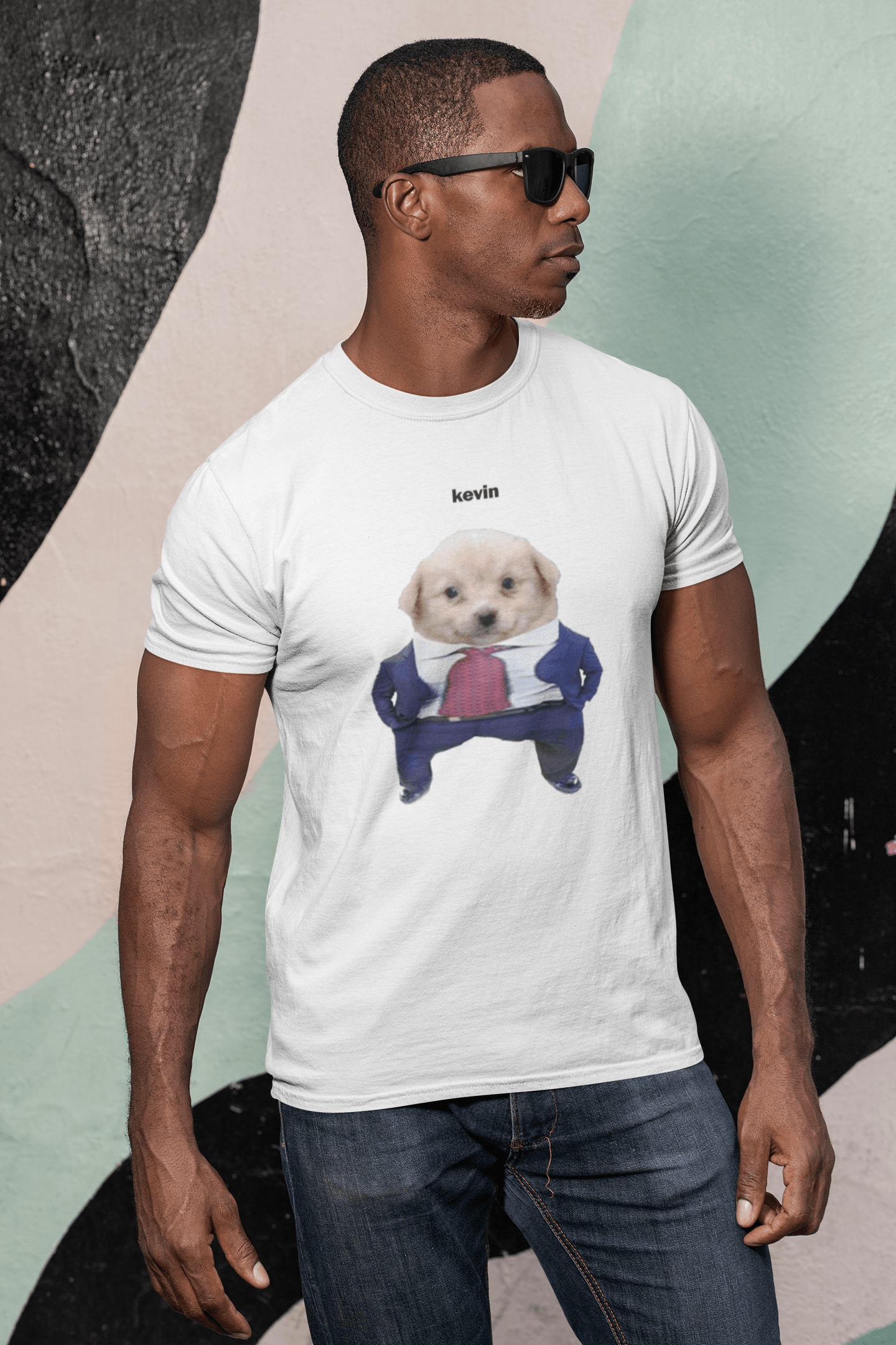 A man wears a white T-shirt featuring a cute dog wearing a suit written &quot;kevin&quot; on top of him.