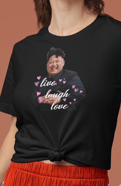 A woman wearing a black T-shirt with kim jong un laughing saying &quot;Live Laugh Love&quot;.