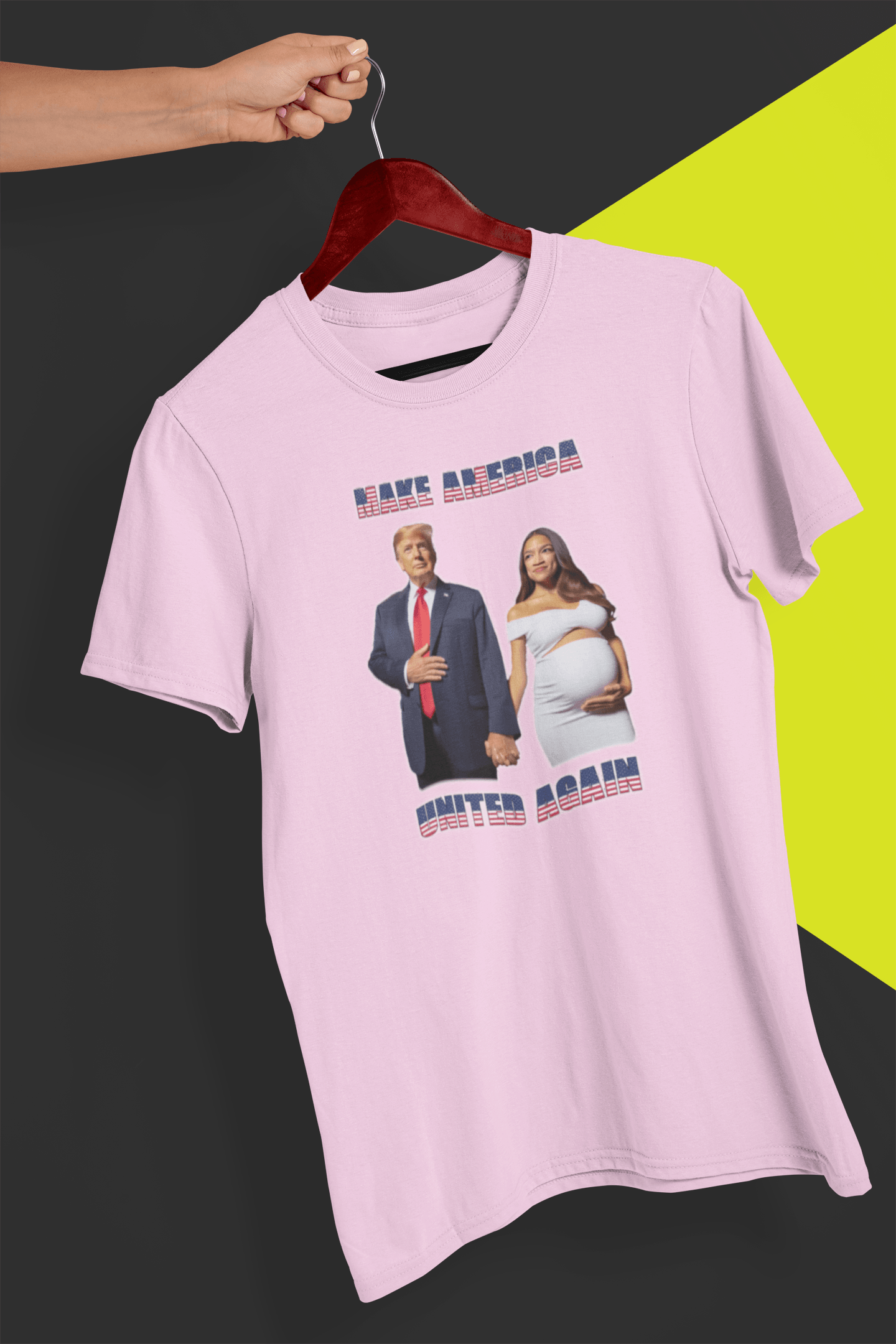 A pink T-shirt with an AI depiction of Donald Trump and pregnant AOC holding hands, saying &quot;Make America United Again&quot;, held by a hand against a split black and yellow background.