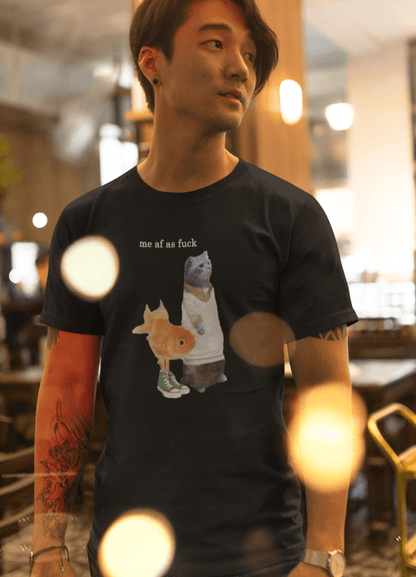 A person wears a black T-shirt featuring a cute cat and fish portraying Gumball and Darwin with &quot;me af as fuck&quot; written on top.