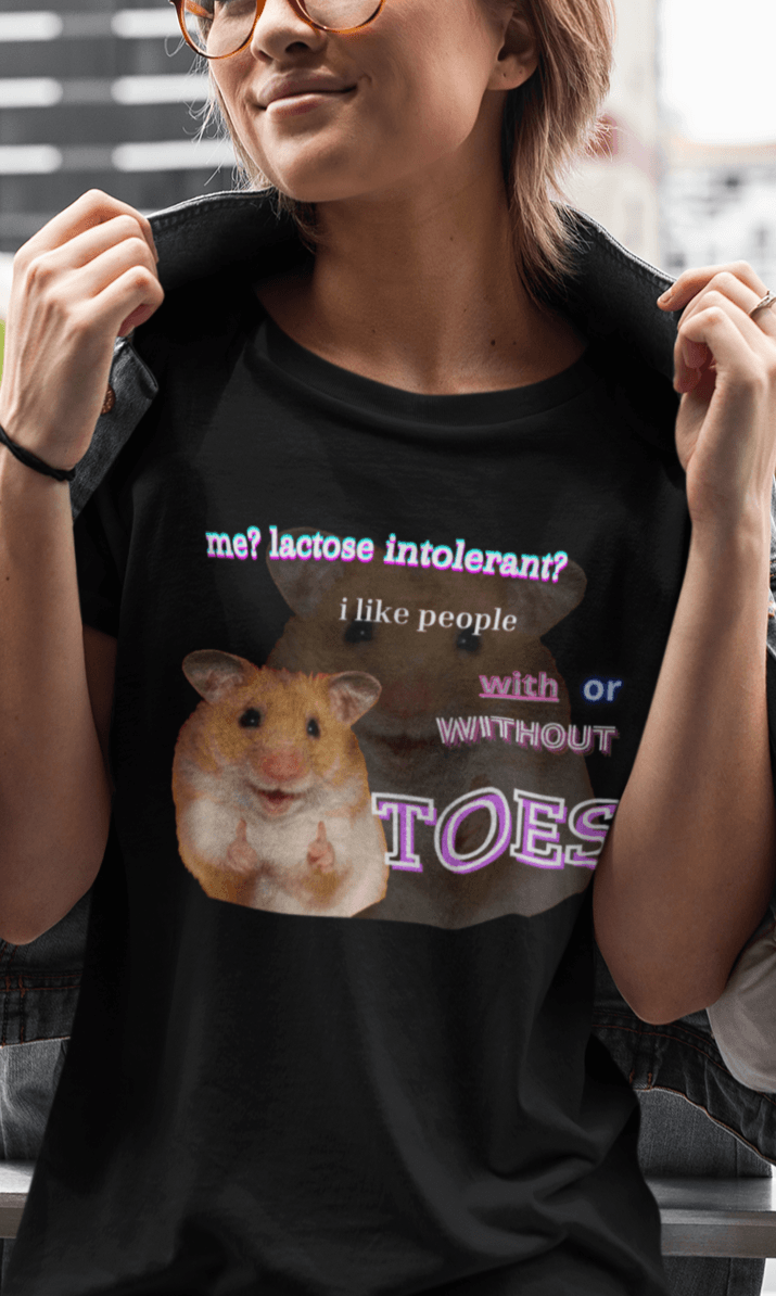 A woman wears a black T-shirt featuring a cute hamster doin a thumbs up written &quot;Me? Lactose intolerant? I like people with or without TOES&quot;