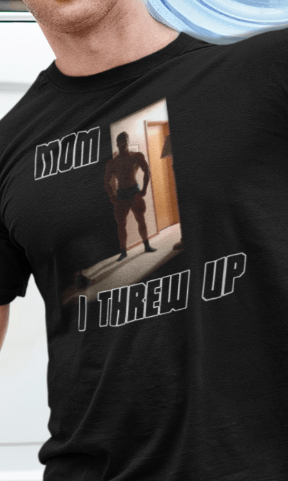 A man wears a black T-shirt featuring a strong man written &quot;Mom I threw up&quot;