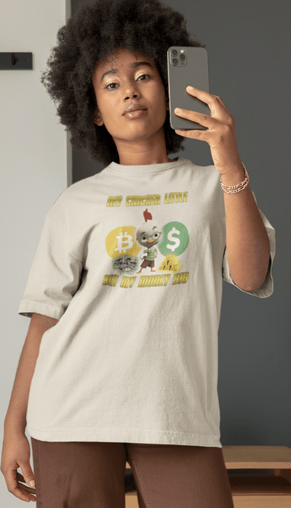 A woman wears an off-white T-shirt featuring Chicken Little that says &quot;My Chicken Little But My Money Big&quot;.