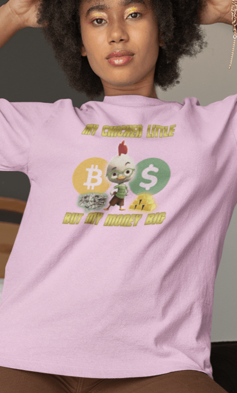 A woman wears a pink T-shirt featuring Chicken Little that says &quot;My Chicken Little But My Money Big&quot;.