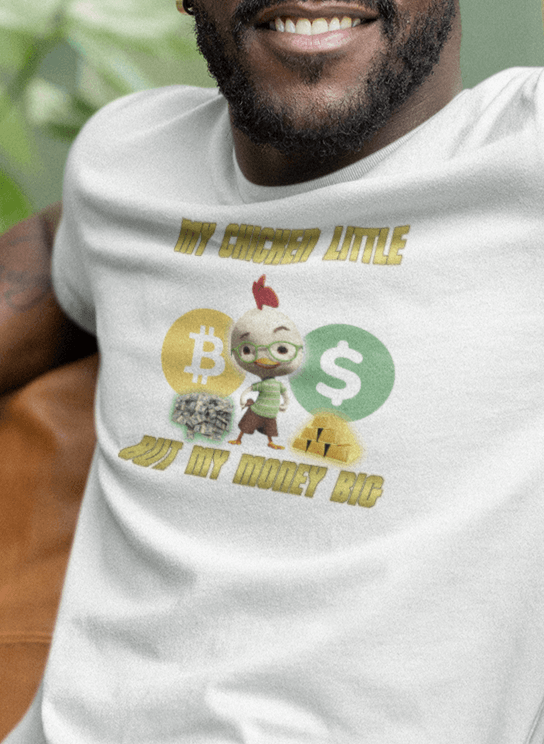 A man wears a white T-shirt featuring Chicken Little that says &quot;My Chicken Little But My Money Big&quot;.