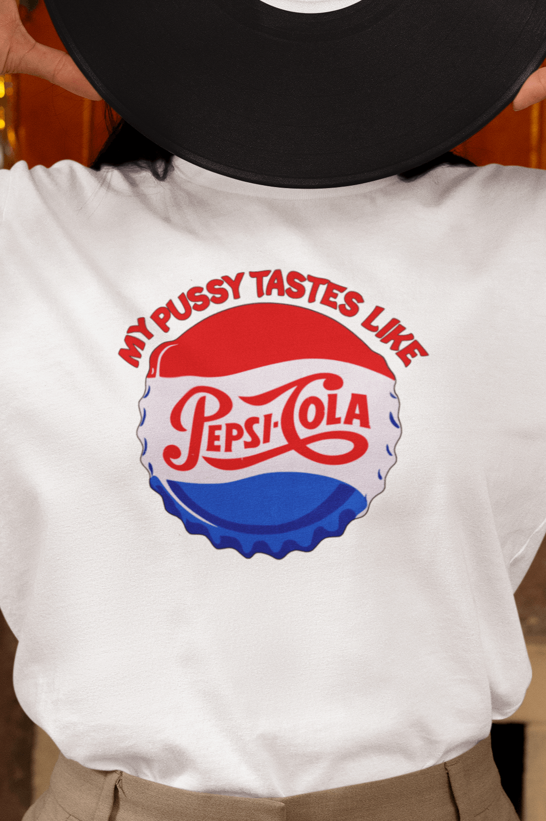 A woman wears a white T-shirt that says &quot;My pussy tastes like Pepsi Cola&quot;