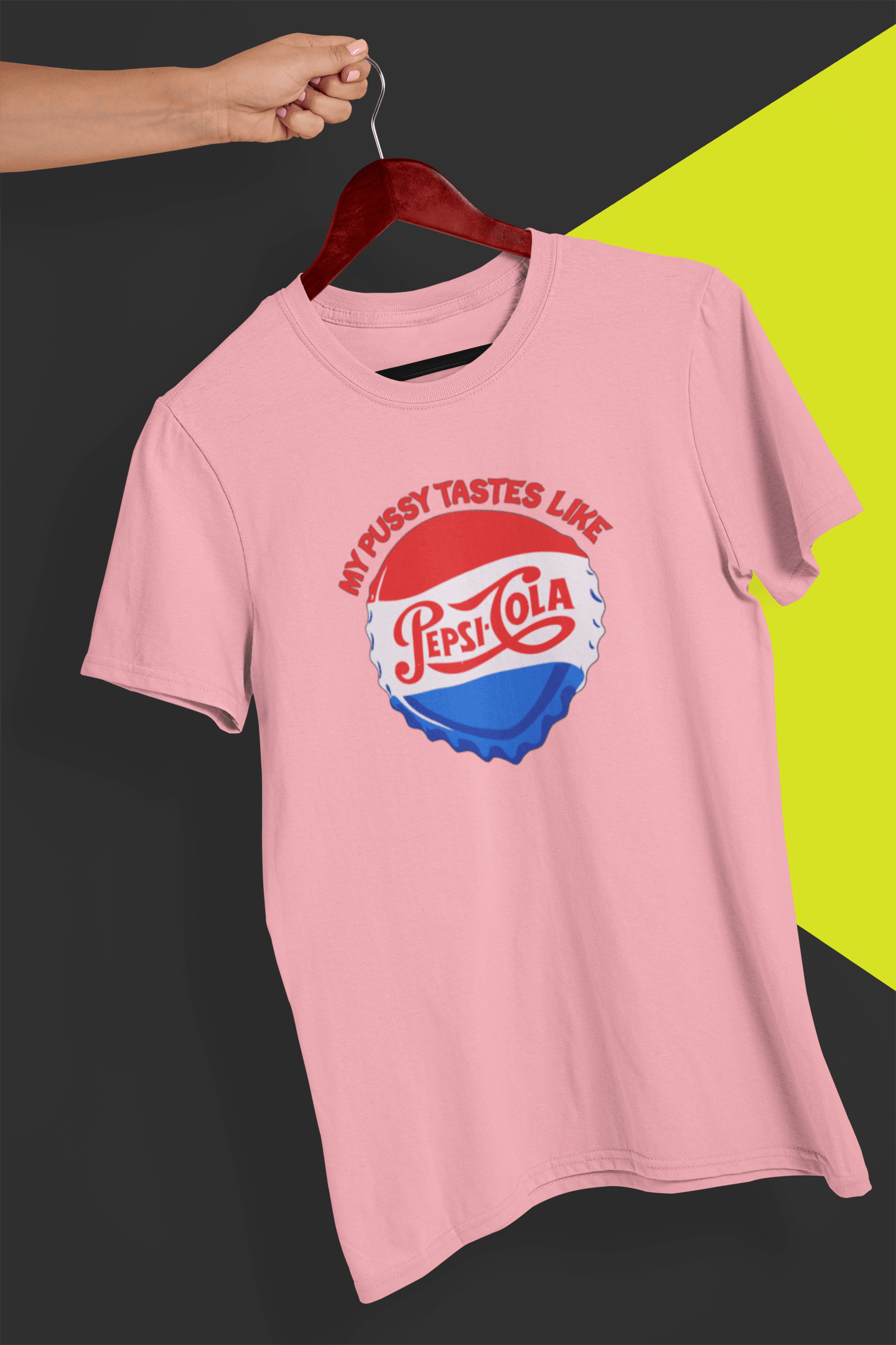 A pink T-shirt that says &quot;My pussy tastes like Pepsi Cola&quot;, held by a hand against a split black and yellow background.