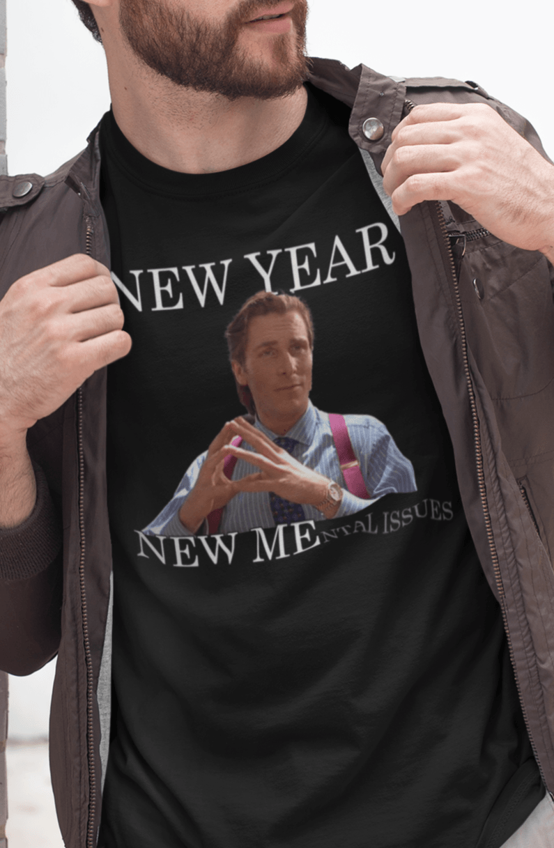 A man wears a black T-shirt featuring Christian Bale in american psycho, saying &quot;New Year, New Mental Issues&quot;.