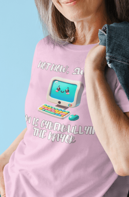 A woman wears a pink T-shirt featuring a cute computer written &quot;Not now, sweetie, mom is cyberbullying the mayor&quot;.