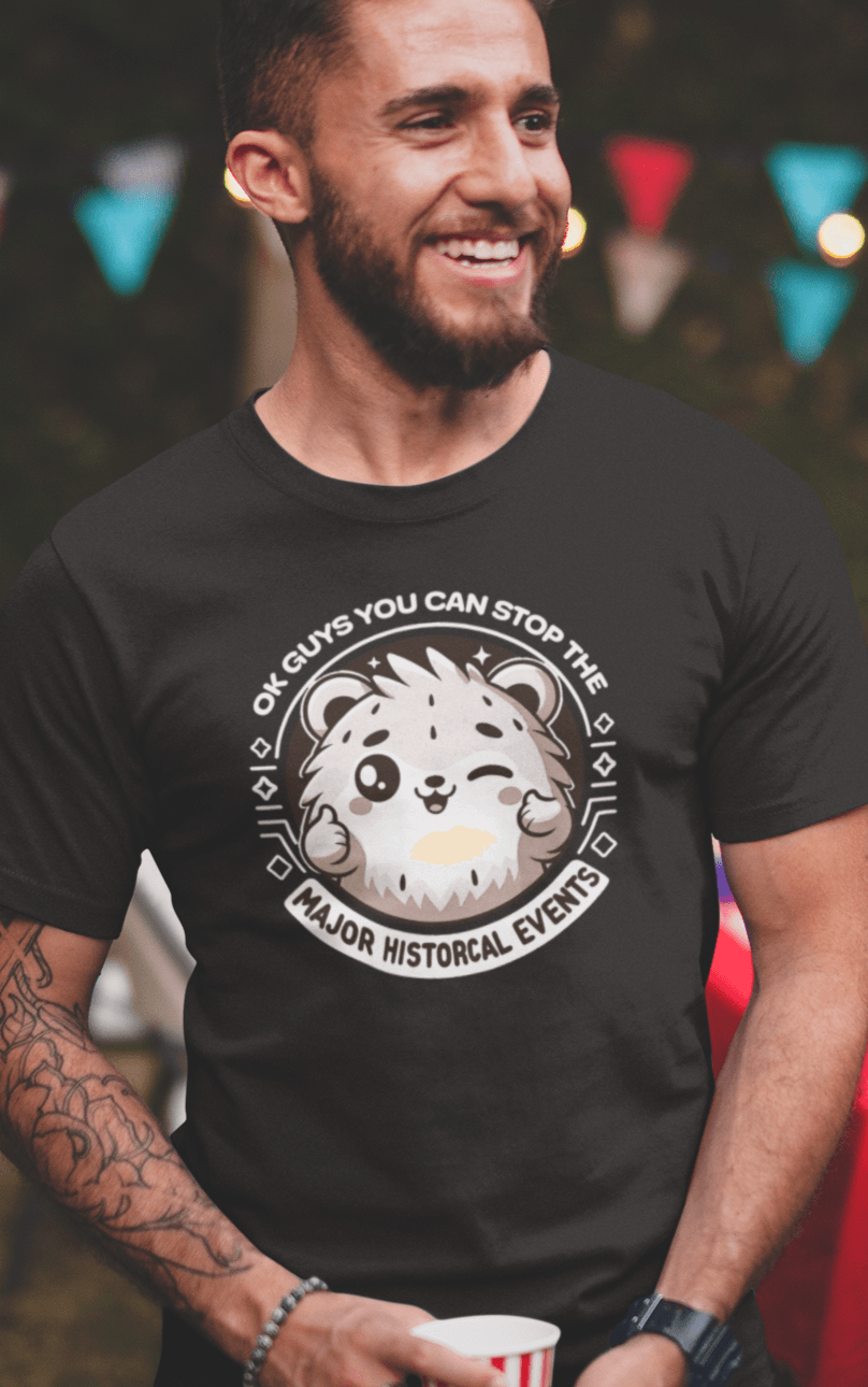 A man wears a black T-shirt featuring a cute hamster doing a thumbs up written &quot;OK GUYS YOU CAN STOP THE MAJOR HISTORICAL EVENTS&quot;.