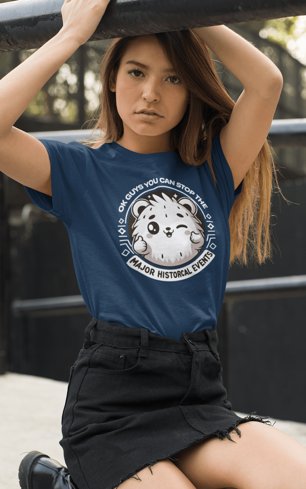 A woman wears a navy T-shirt featuring a cute hamster doing a thumbs up written &quot;OK GUYS YOU CAN STOP THE MAJOR HISTORICAL EVENTS&quot;.