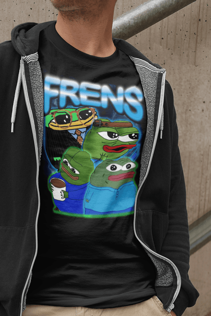 A person wears a black T-shirt featuring four cute pepes and peepos written &quot;FRENS&quot; on top.