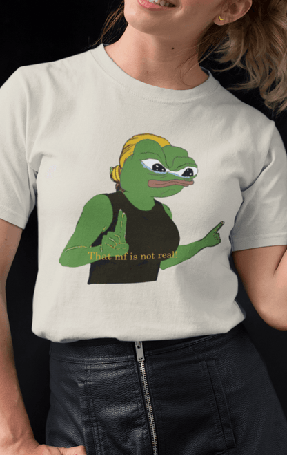 A woman wears a white T-shirt featuring a cute apu apustaja pepe in the middle pointing and written &quot;That MF isn&#39;t real!&quot;.