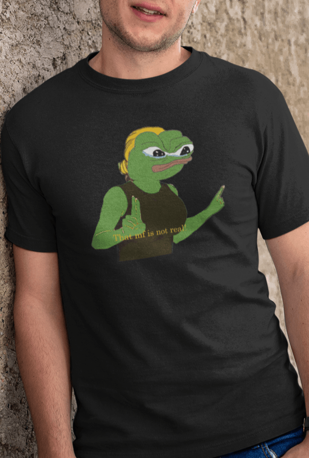 A man wears a black T-shirt featuring a cute apu apustaja pepe in the middle pointing and written &quot;That MF isn&#39;t real!&quot;.