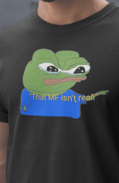 A man wears a black T-shirt featuring a cute apu apustaja pepe in the middle pointing and written &quot;That MF isn&#39;t real!&quot;.