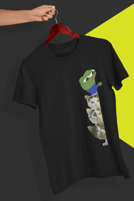 A black T-shirt with a a cute apu apustaja pepe with three kittens on the side, held by a hand against a split black and yellow background.