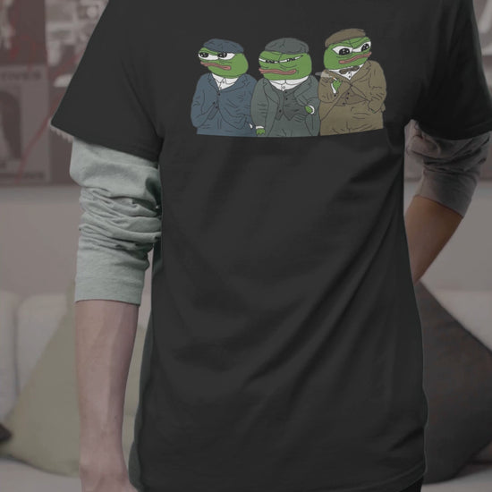 A video a man wearing a black T-shirt featuring three cute apu apustaja pepe in the middle wearing peaky blinders clothes.