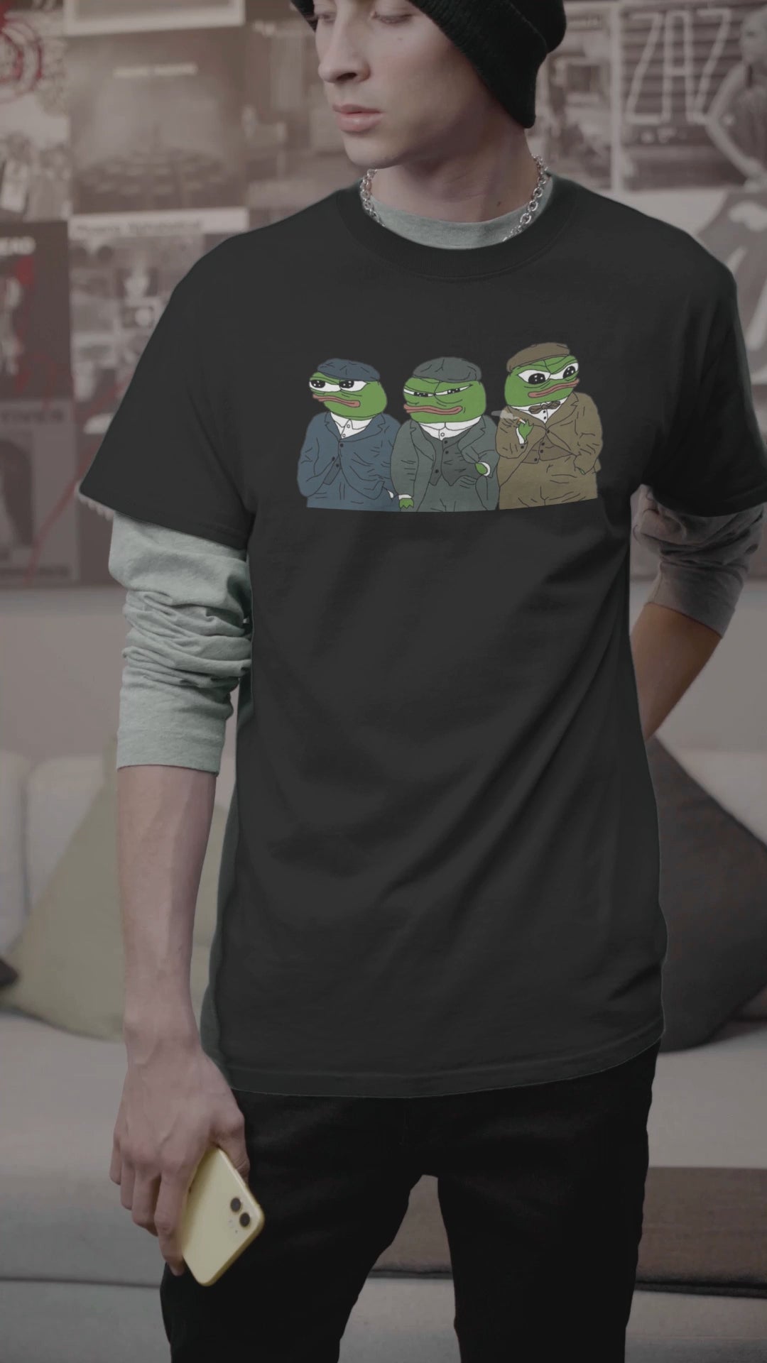 A video a man wearing a black T-shirt featuring three cute apu apustaja pepe in the middle wearing peaky blinders clothes.