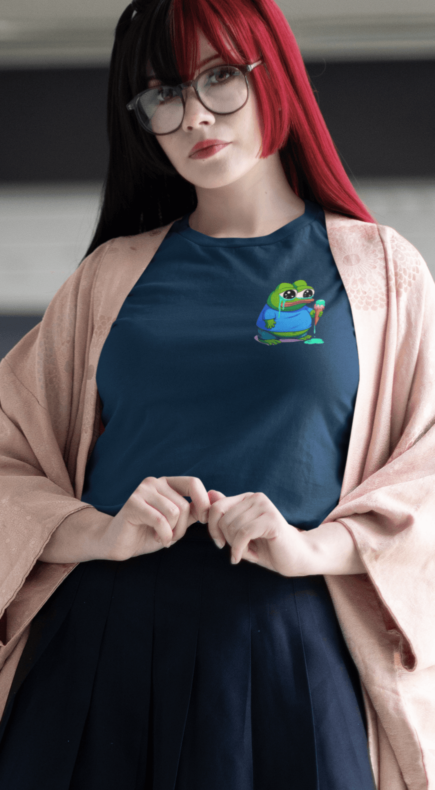 A woman wears a navy blue T-shirt featuring a small cute apu apustaja pepe in the right corner.