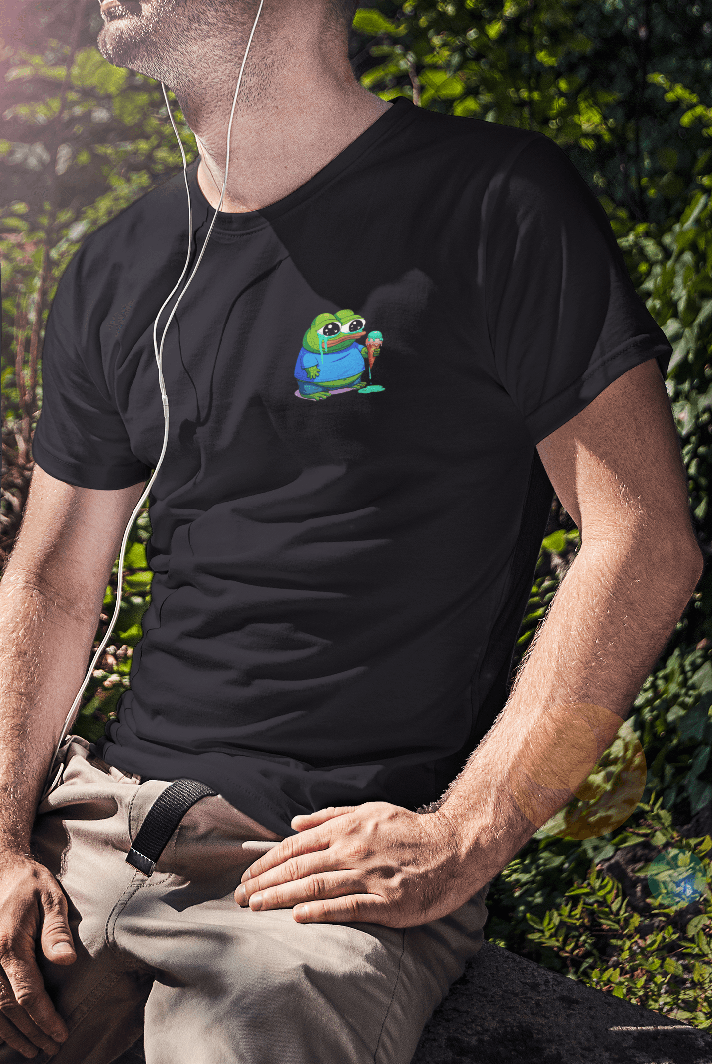 A man wears a black T-shirt featuring a small cute apu apustaja pepe in the right corner.