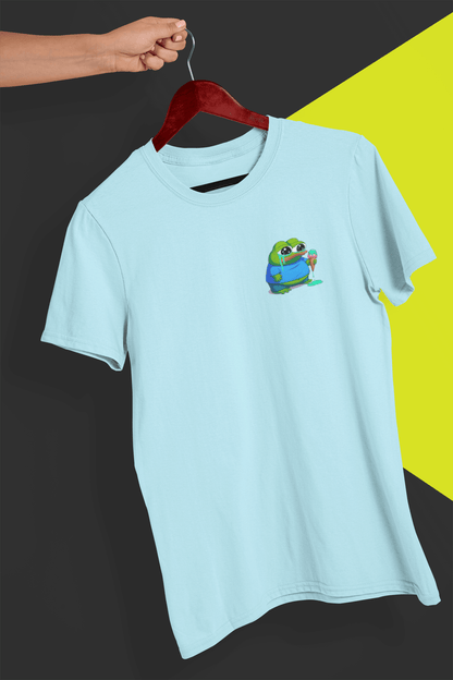 A light blue T-shirt with a small cute apu apustaja pepe in the right corner, held by a hand against a split black and yellow background.